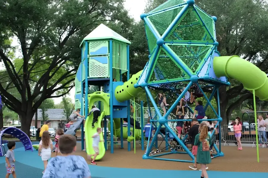 Children playing on the playground at Carol Fox Memorial Park in Jersey Village, Texas