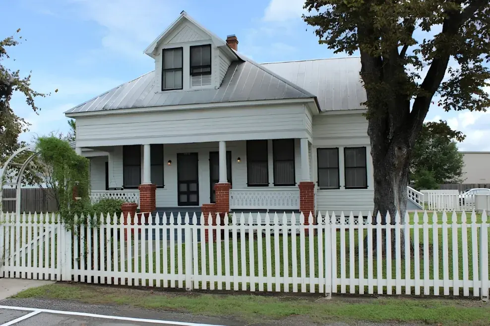 Historic white house with a picket fence at Cypress Top Historic Park in Cypress, Texas, near Blueprint Mental Health in Katy