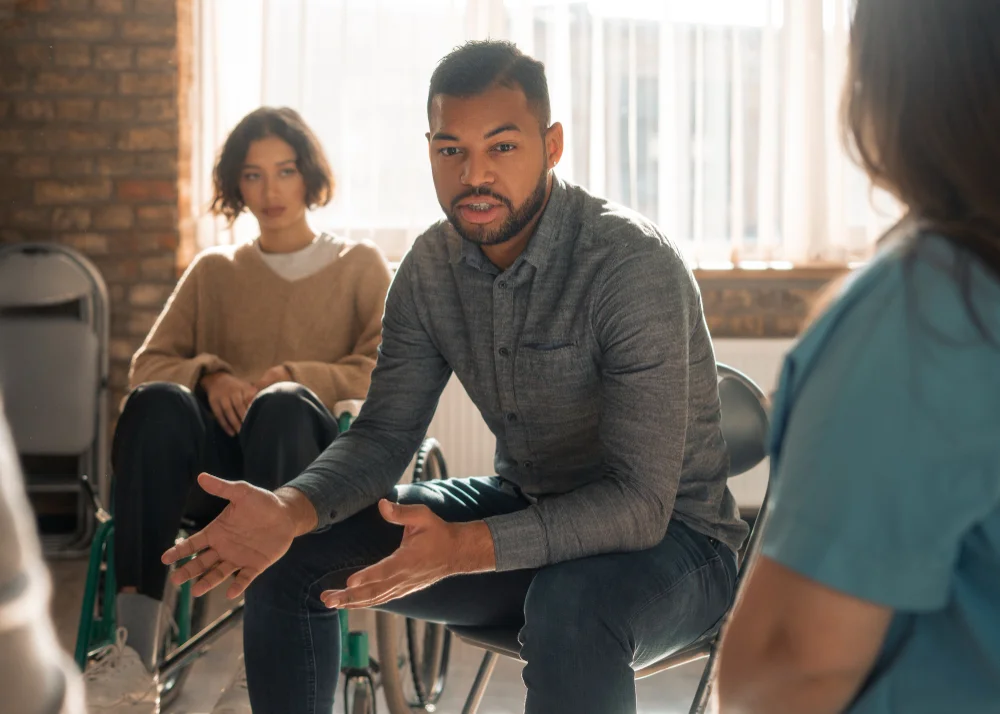 Participant sharing during a group therapy session in Katy, Texas