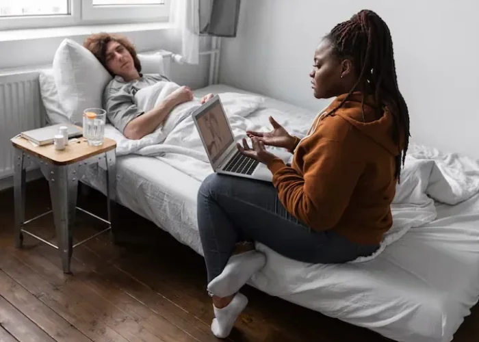 Woman speaking with a provider on a laptop during a telehealth session for PTSD treatment in Katy, Texas