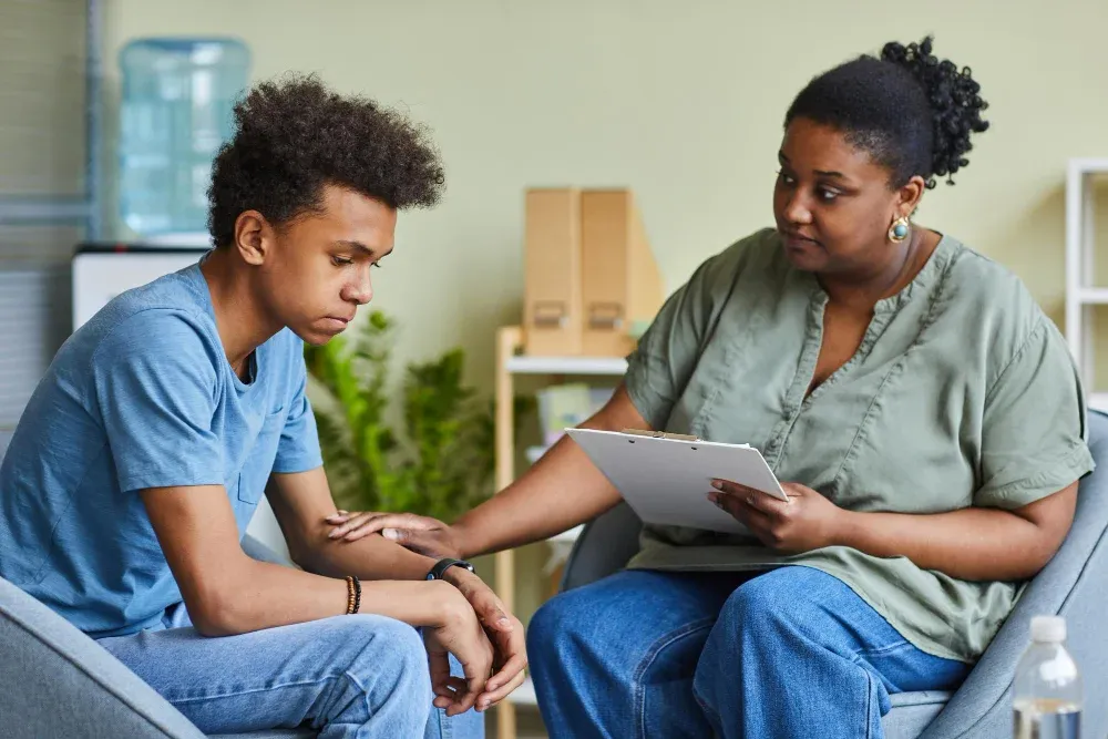 Therapist comforting a teenage client during a counseling session at Blueprint Mental Health in Katy, TX